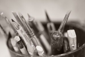 black and white close up photo of carving tools for pottery