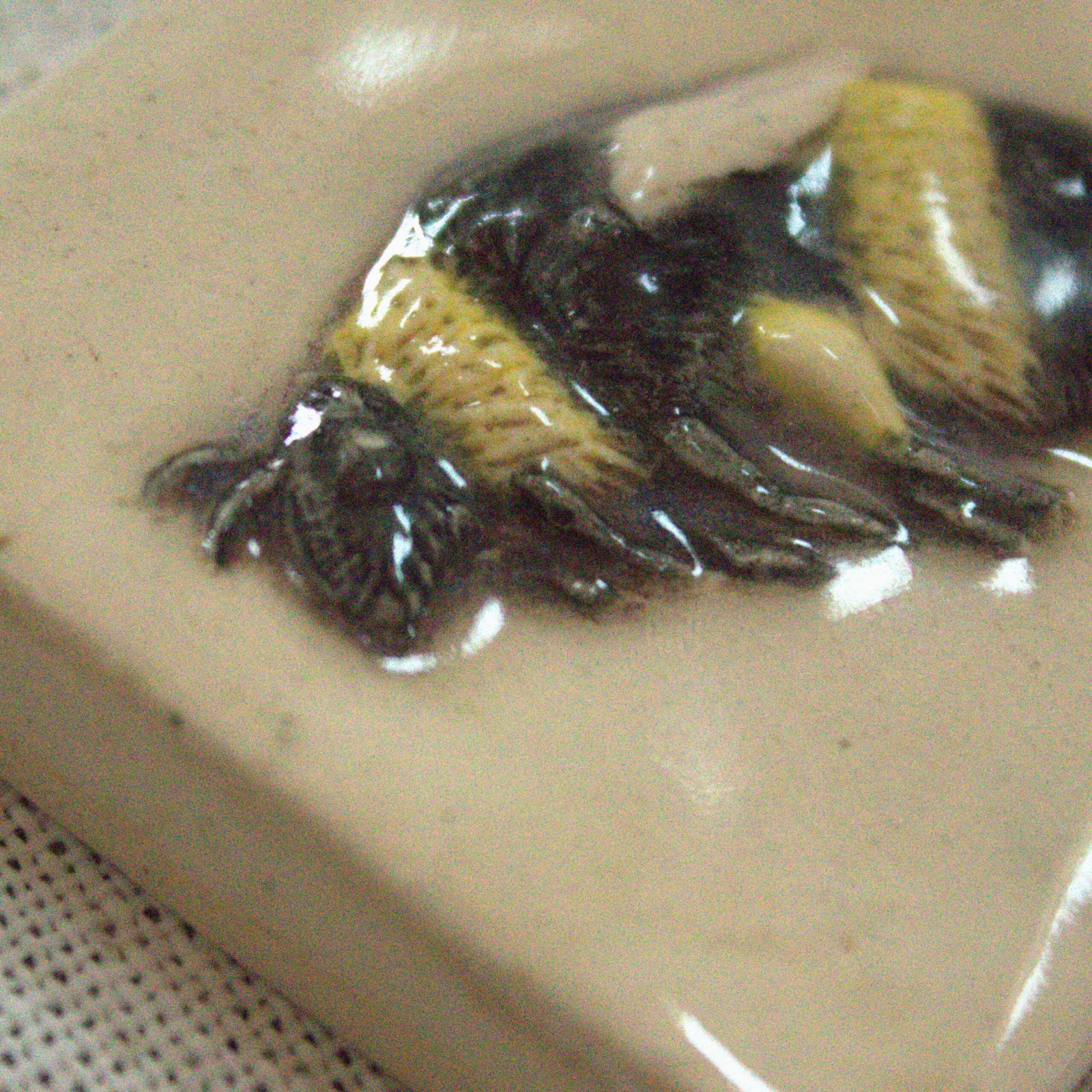 Close up of handcarved details of the 2-inch bumblebee ceramic tile