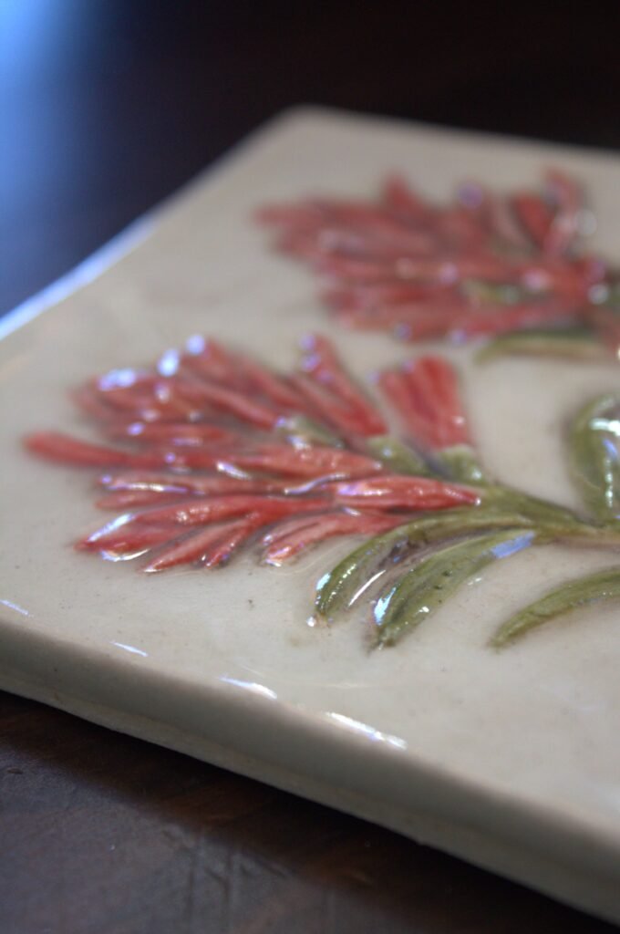 Close view of the hand carved details of the Indian Paintbrush 4-inch accent tile.