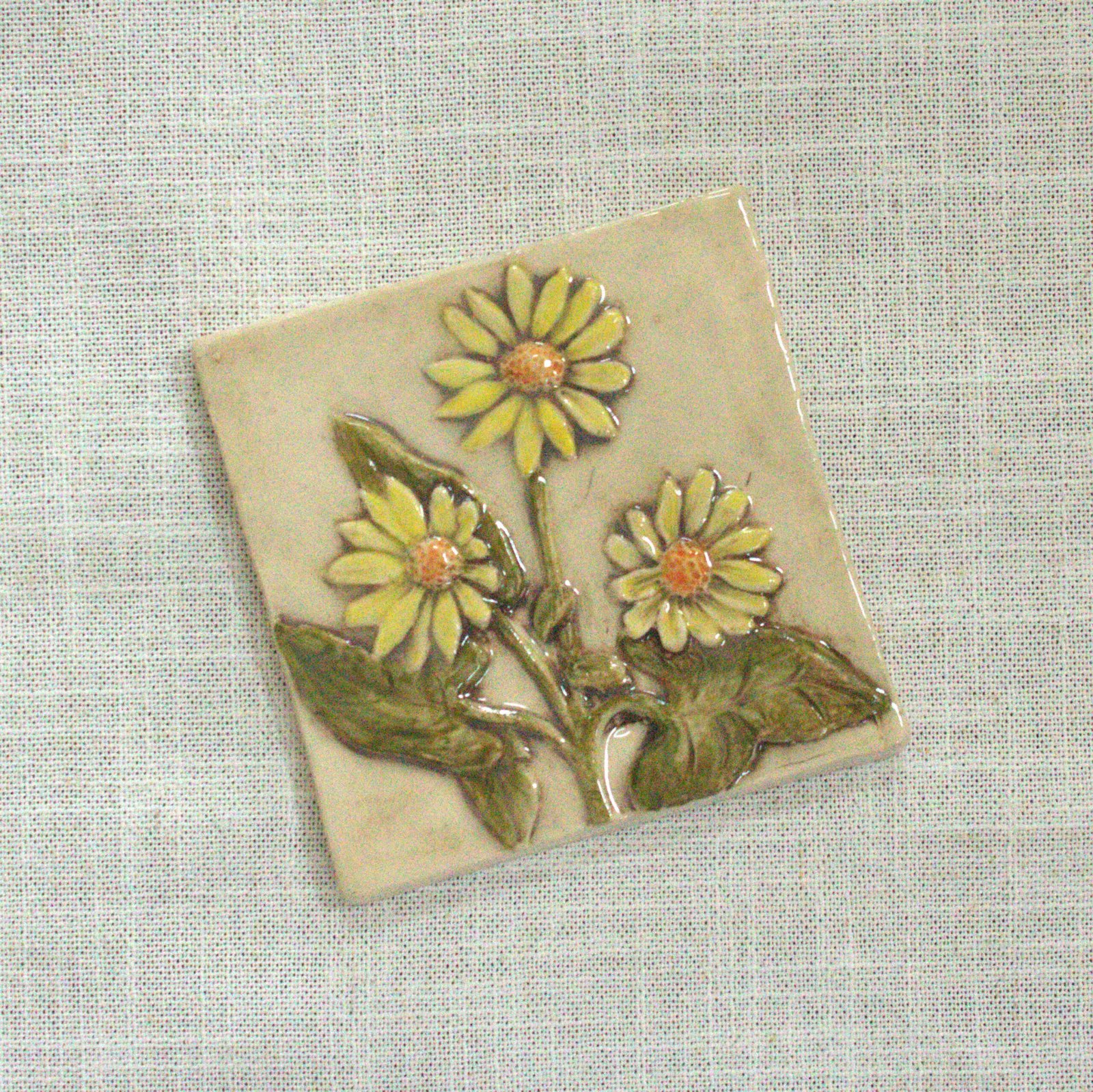 4 inch hand carved and hand painted ceramic tile of a grouping of yellow flowered Balsamroot Flowers
