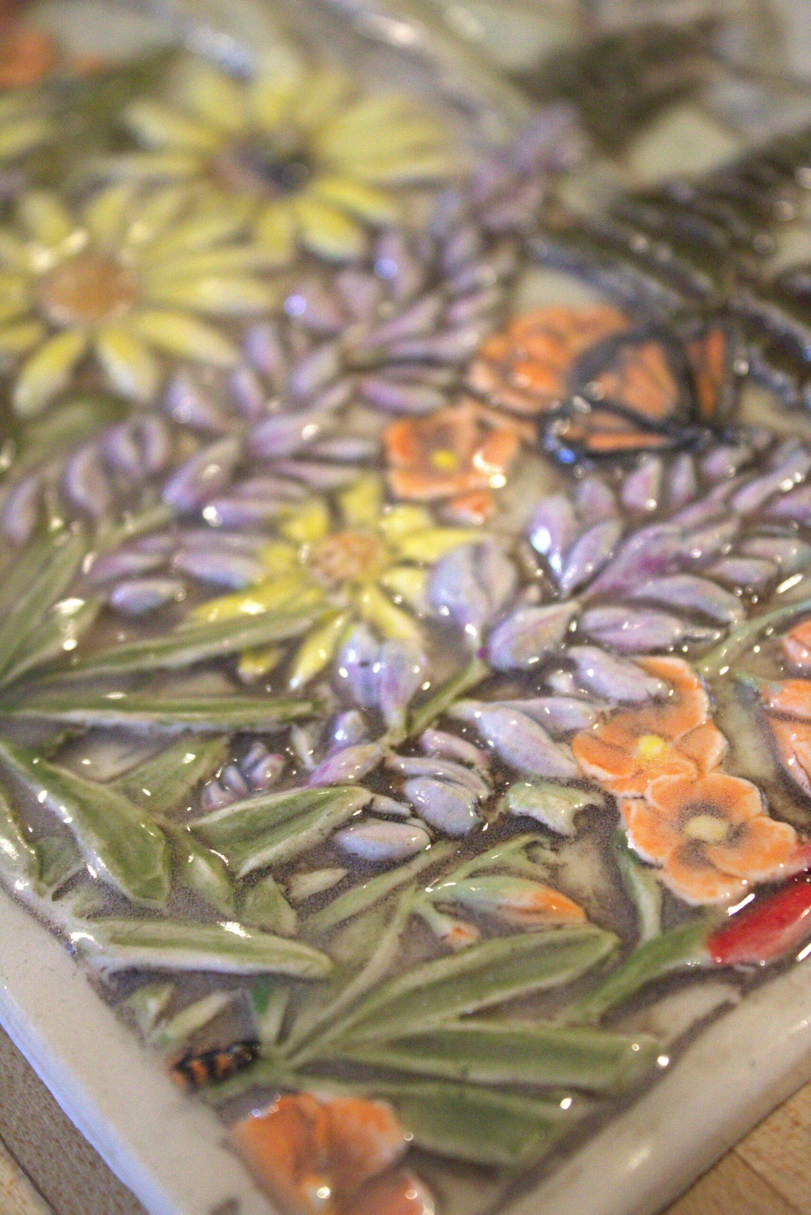 Close up photo of the carving detail in the Mountain Bloom 8 x12 tile made by Fire Creek Clay