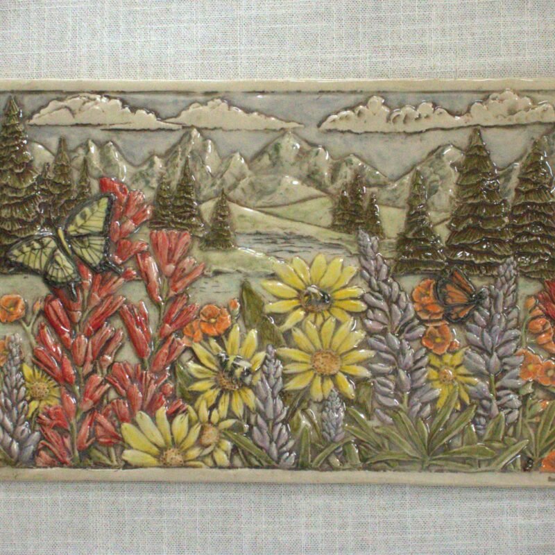 Handcrafted ceramic art tile featuring Wyoming wildflowers including Paintbrush, Lupin, and Arrow Leaf Balsamrootwith native bees and butterflies