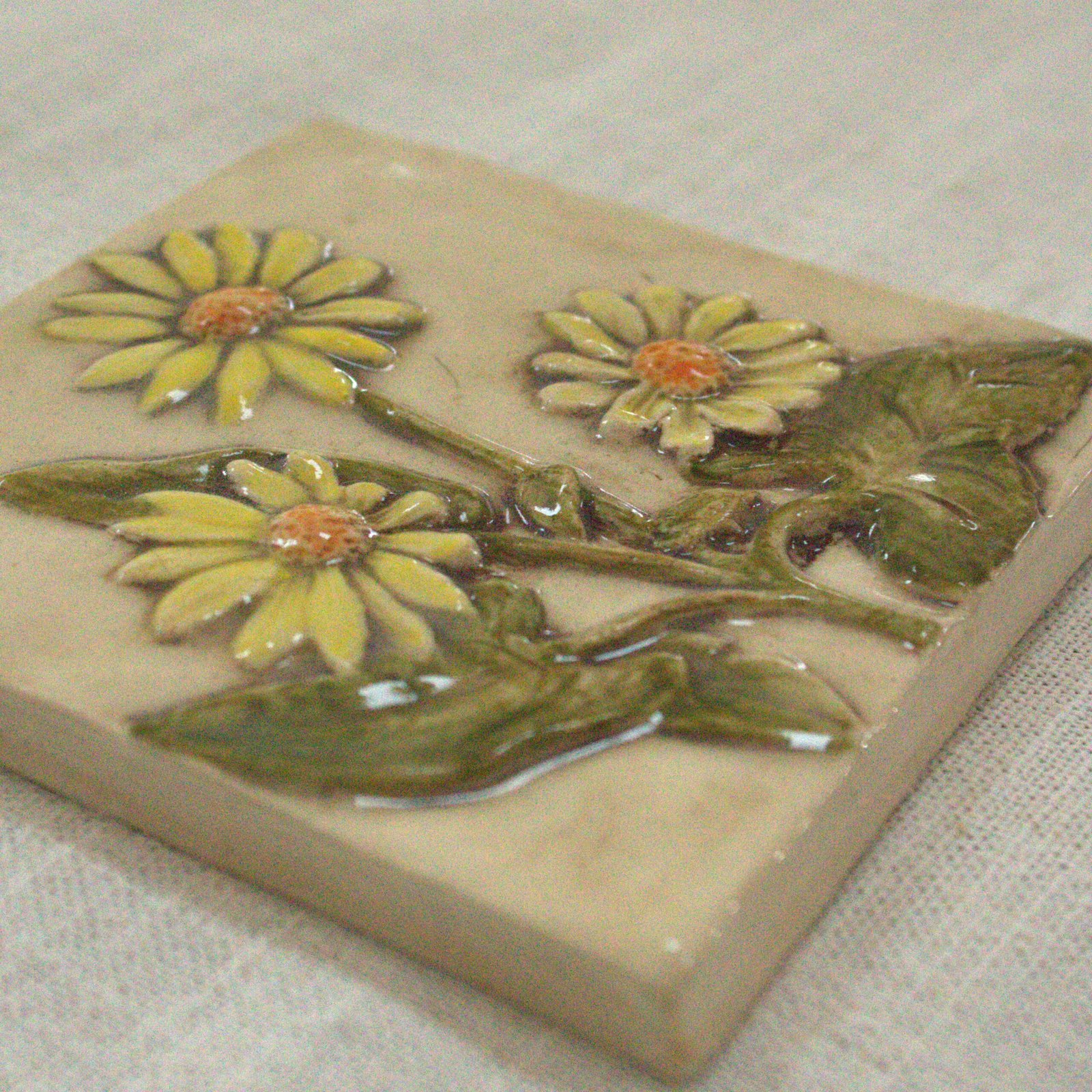Closeup of the 4 inch hand carved and hand painted yellow flowered Balsamroot flower